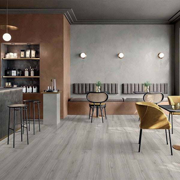 Modern café with light gray wood-look flooring, sleek furniture, and warm ambient lighting for stylish interiors.